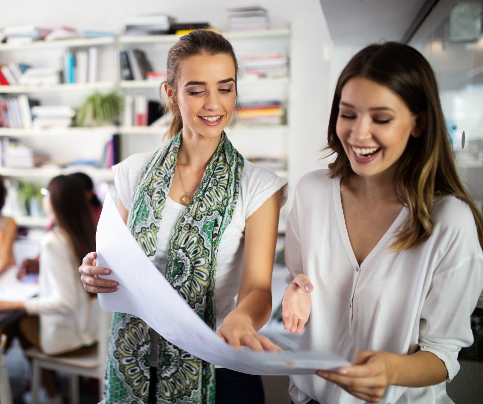 Two business women looking at some plans